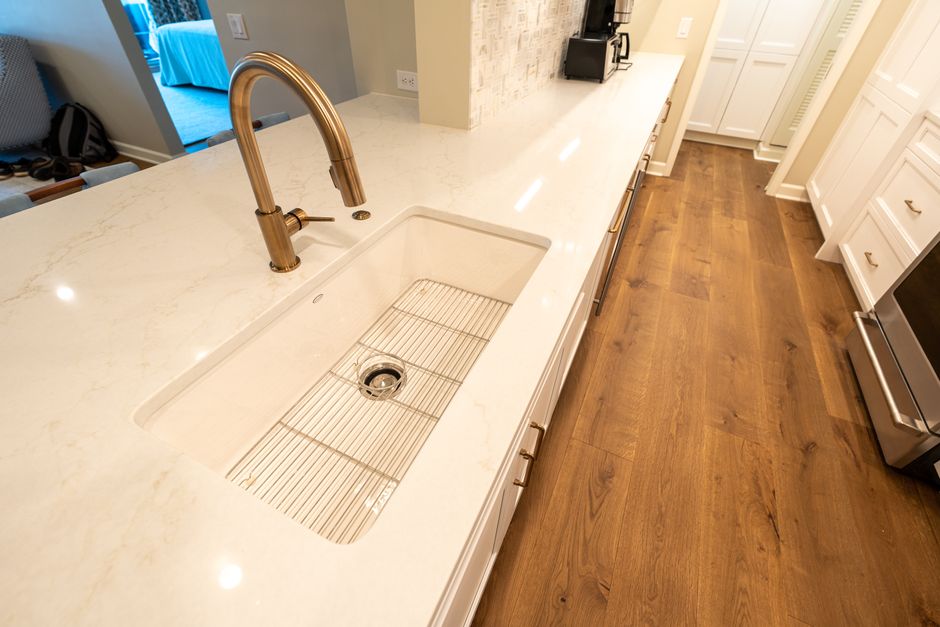 A clean, modern kitchen featuring a marble countertop and sleek fixtures.